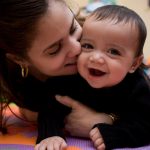 adorable-hispanic-young-mother-and-son-in-home-playroom-picture-id157404160