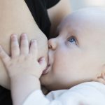 Breast feeding of a newborn baby boy