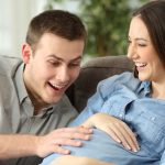 happy-husband-and-pregnant-woman-expecting-birth-picture-id808486934