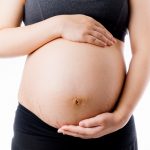 Happy pregnant woman touch belly