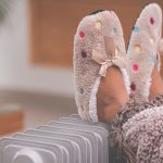 little-girls-feet-in-slippers-on-radiator-heater-picture-id1202108660