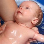 mom-holding-newborn-infant-in-blue-plastic-tub.jpg_s=1024×1024&w=is&k=20&c=98Oyvy8dBzs2xlBCivdoWyZvxp_Cb07tmaPgpPUTxVo=