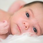 newborn-baby-is-looking-at-the-camera-picture-id525952017