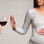 pregnant-lady-gesturing-stop-to-glass-of-wine-studio-cropped-picture-id1190131668