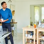 mature-man-working-in-the-kitchen-with-his-wife-picture-id590296236