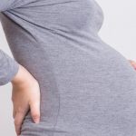 pregnant-woman-has-backache-and-touching-her-torso-picture-id539834824