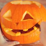 close-up-of-woman-with-pumpkins-at-home-picture-id487525894