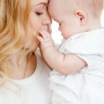 young mother and baby in her hands
