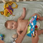 sweet-baby-enjoying-watching-soft-colorful-book-with-pictures-picture-id1344021499