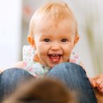Portrait of smiling playing baby at home