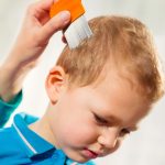 mother-using-a-comb-to-look-for-head-lice-picture-id513381262