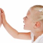 cute little girl talking to her new baby-brother