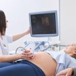 loving-couple-attending-doctor-for-pregnancy-ultra-sound-procedu-picture-id841117286
