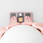 pregnant-woman-with-barefoot-standing-on-weight-scales-care-about-picture-id1179158712