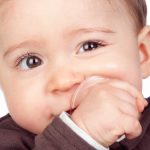 Beautiful baby with a pacifier isolated on white background