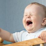 The baby cries and calls mum from a bed