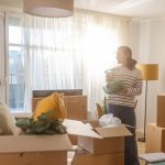 Happy young woman in new apartment