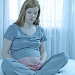 pregnant girl looking very worried,