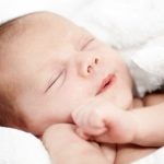 Adorable baby boy wrapped in a blanket and fast asleep – Newborn