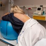 woman-during-contractions-on-a-fitness-ball-parturition-hospital-picture-id1163336551