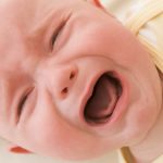 Baby lying indoors crying
