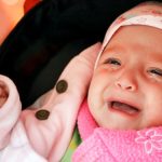 The crying little girl in a carriage