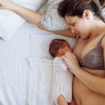 Mother with visible Postpartum body marks breastfeeding