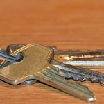 macro photo of a bunch of house keys on a wooden table