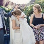 Outdoors traditionnal baby baptism with family.