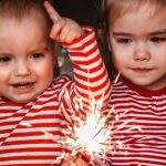 family-holidays-at-home-two-happy-kids-holding-burning-sparkler-picture-id1283892809