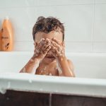 Brothers playing in the bathtub