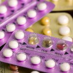Oral contraceptive pill on pharmacy counter.