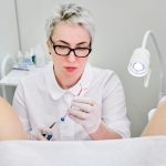 Gynecologist holding an IUD birth control device before using it for patient