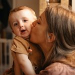 mother-kissing-and-hugging-her-child-picture-id1299790638
