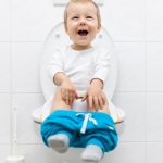 adorable-young-child-sitting-on-the-toilet-picture-id937458886 (1)