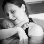 mother-embracing-her-newborn-after-home-water-birth-picture-id510951457