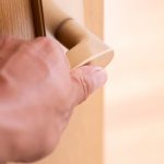 Human hand grabbing a doorknob