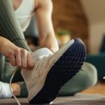 closeup-of-athletic-woman-putting-on-sneakers-picture-id1210120932