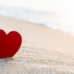 red-heart-shape-on-the-beach-picture-id1182610206