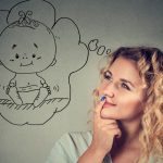 young-woman-dreaming-of-baby-picture-id916863322