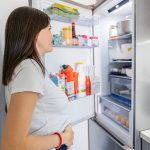 Mid-Adult Pregnant Woman Opening Fridge To Have A Snack