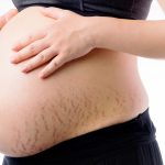 Happy pregnant woman touch belly