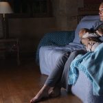 Mother breastfeeding with television