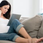 Pregnant woman with digital tablet computer