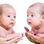 twins brothers babies lying on green