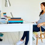 Pregnant woman sitting in home office