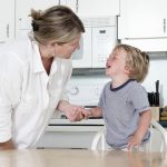 Mother trying to calm crying child at home