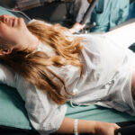 Woman in Active Labor Pushing During Childbirth in Hospital