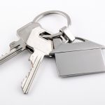 keys-and-house-chrome-pendant-with-home-shape-picture-id488849234