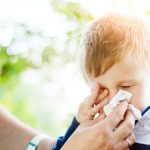 little-boy-having-allergy-problems-in-nature-picture-id975115022